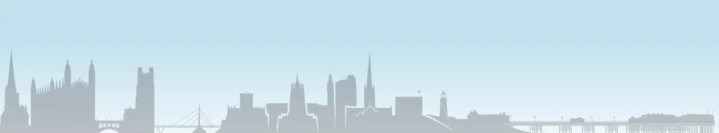 A silhouette of a city with a bridge and skyscrapers.